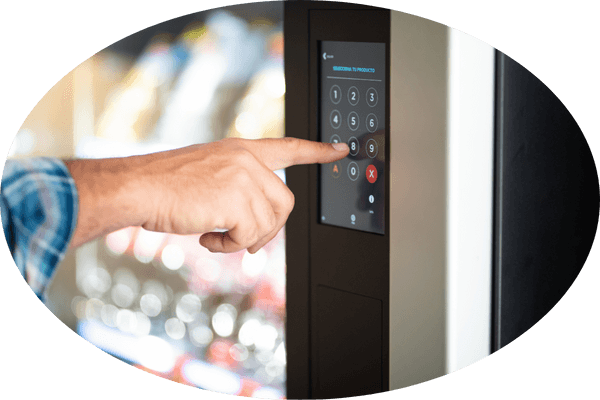 Customer selecting a snack on a vending machine keypad